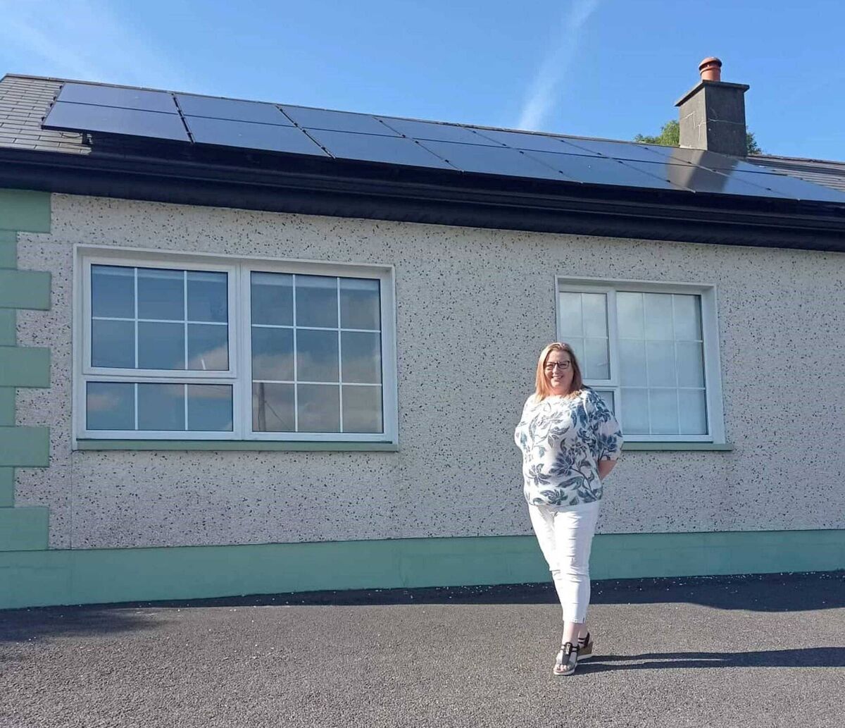 Corrie Crawford stands under her 4.8kWp PV array in County Donegal. Corrie Crawford stands under her 4.8kWp PV array in County Donegal.