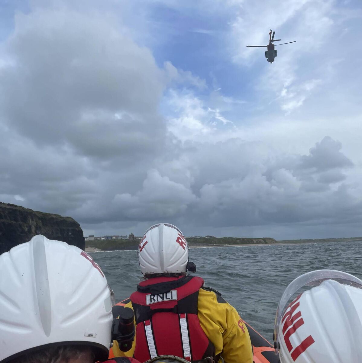 RNLI crew and Rescue 115 at the scene.