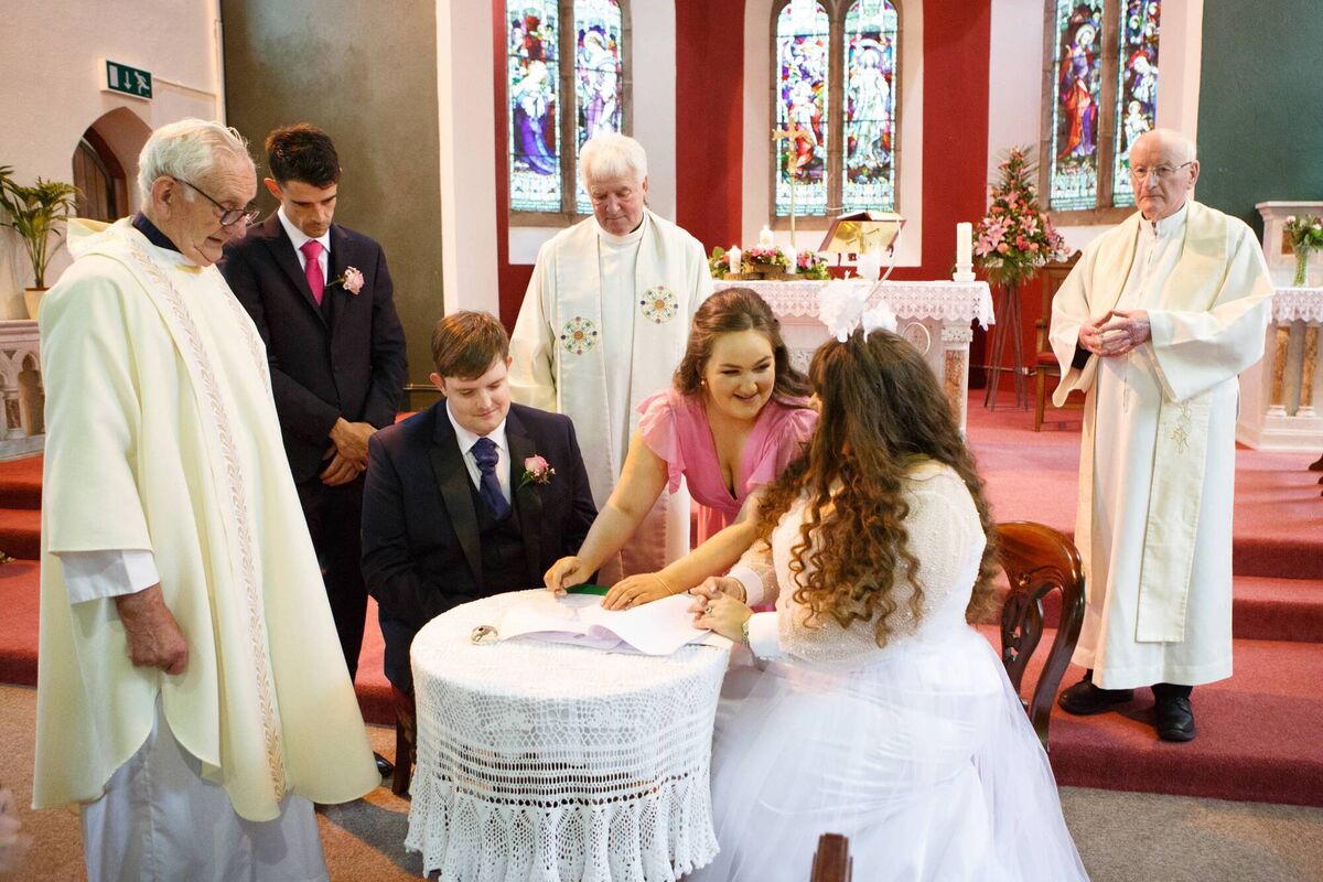 Annmarie and Anthony sign the register. Pictures: Healy & Rimmington Photography Annmarie and Anthony sign the register. Pictures: Healy & Rimmington Photography