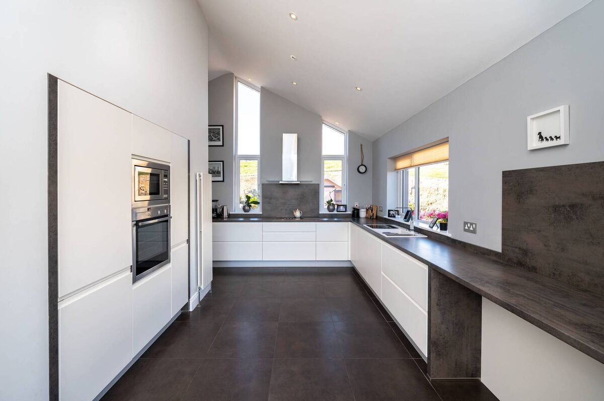The kitchen at the side has sliding doors out to a composite deck seating area. The kitchen at the side has sliding doors out to a composite deck seating area.