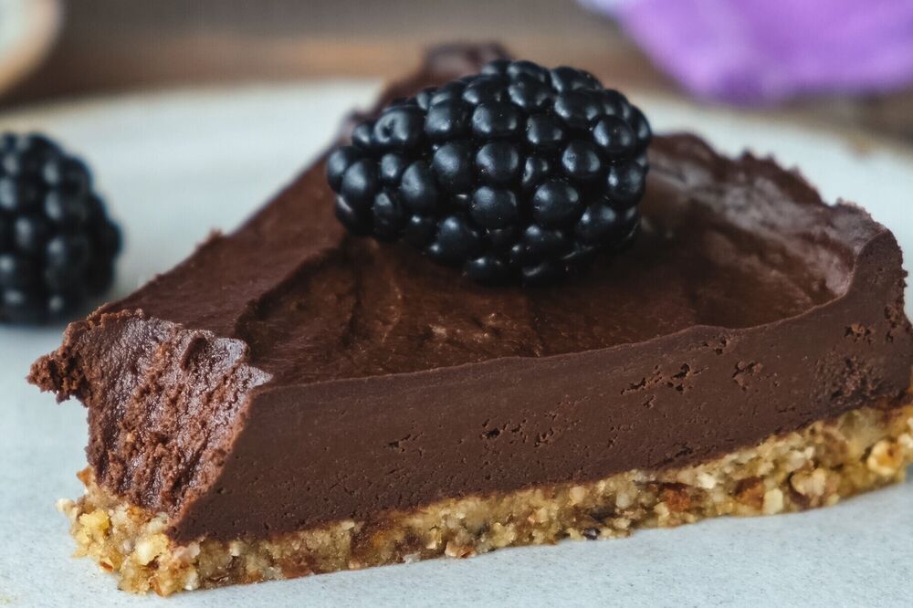 Chocolate tart served with blackberries