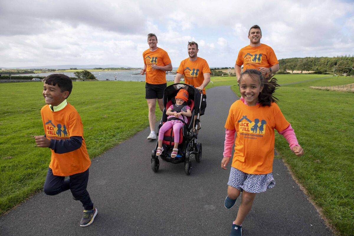 Jack Carty and teammates Gavin Thornbury and Tom Farrell with Lily and Edel Parackal and Lily's siblings Jacob, 7, and Tess, 8, in Rinville Park, Galway, urging people to go Up the Hill for Jack and Jill during the month of October.
