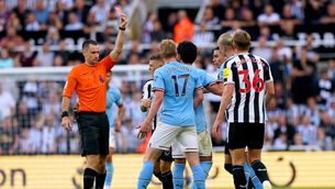 <p>SILENCE THE CRITICS: Referee Jarred Gillett shows a red card to Newcastle United's Kieran Trippier for a foul on Manchester City's Kevin De Bruyne before a VAR check later downgrades it to a yellow. Photo: Owen Humphreys/PA Wire.</p>