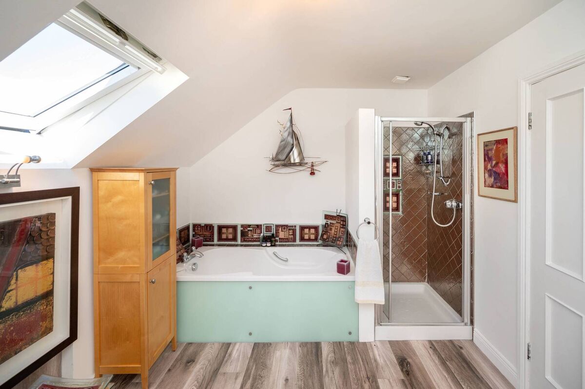 Family bathroom with glass side bath panel