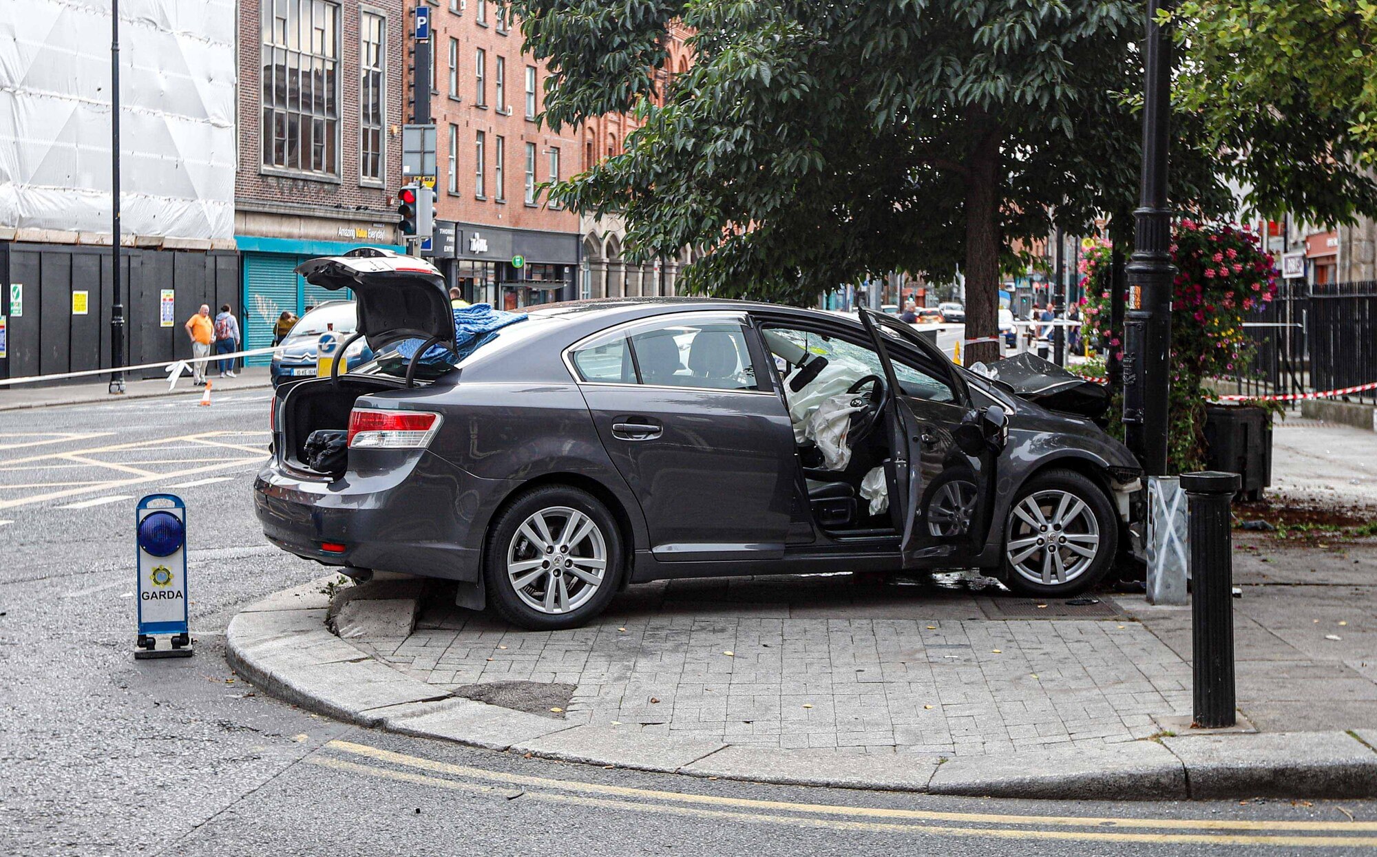 Man arrested after car mounted footpath and struck three pedestrians