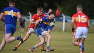 <p>UNDER PRESSURE: Kevin Kavanagh, Carrigaline holds possession under pressure from Joe Cooper, Eire Og in front of goals in the Bon Secours 2022 Premier Intermediate Football Championship; Carrigaline vs Eire Og at Ballygarvan. Pic: Larry Cummins</p>
