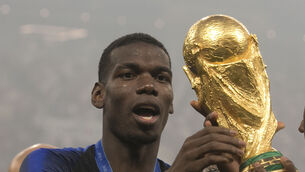 <p>REIGNING CHAMPIONS: France's Paul Pogba celebrates with the trophy after winning the FIFA World Cup in 2018. Knee surgery could rule him out of Qatar 2022. Pic: PA</p>
