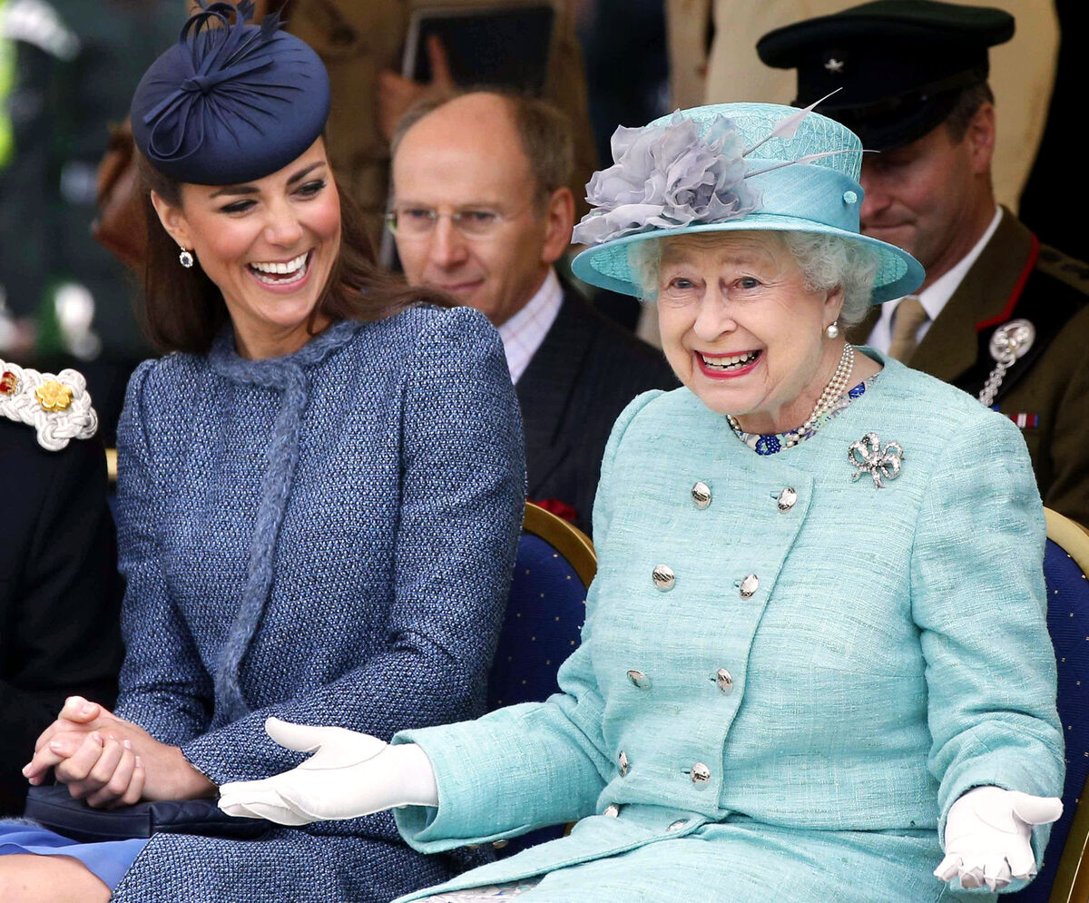 Kate laughs as Queen Elizabeth gestures while they watched part of a children's sports event during a visit to Vernon Park in Nottingham.