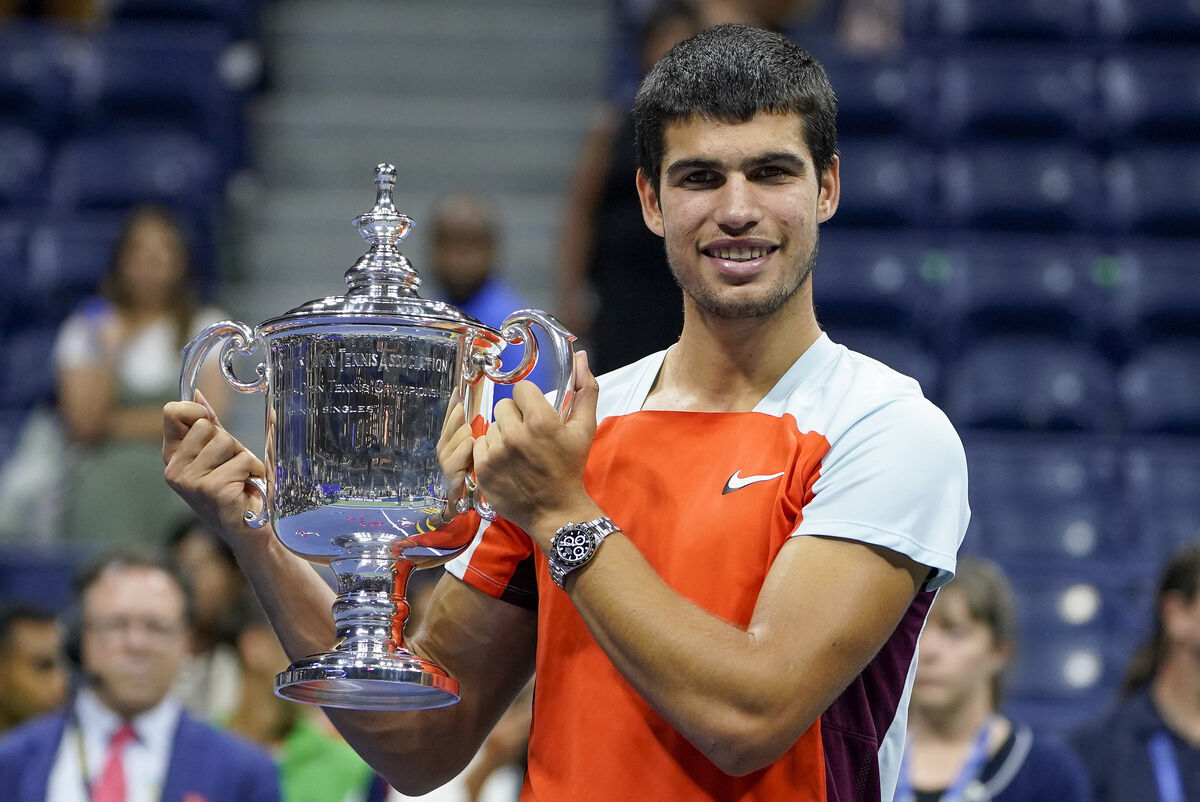 Carlos Alcaraz, of Spain, poses with the championship trophy after defeating Casper Ruud, of Norway, in the men's singles final of the U.S. Open tennis championships, Sunday, Sept. 11, 2022, in New York. (AP Photo/John Minchillo)