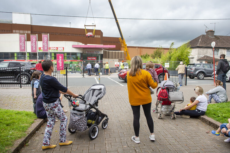  People watch the cars being lifted from the car park at Douglas Village Shopping Centre after the fire in 2019. Picture: Dan Linehan