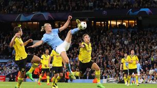 <p>ACROBATICS: Erling Haaland of Manchester City scores a goal to make it 2-1 during the UEFA Champions League group G match between Manchester City and Borussia Dortmund. (Photo by Robbie Jay Barratt - AMA/Getty Images)</p>