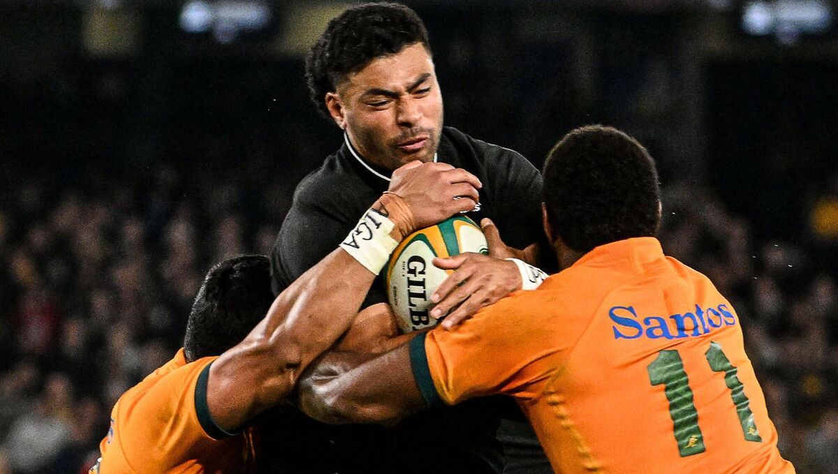 New Zealand's Richie Mounga (C) scores a try despite Australia's Len Ikitau (L) and Australia's Marika Koroibete (R) at Marvel Stadium in Melbourne