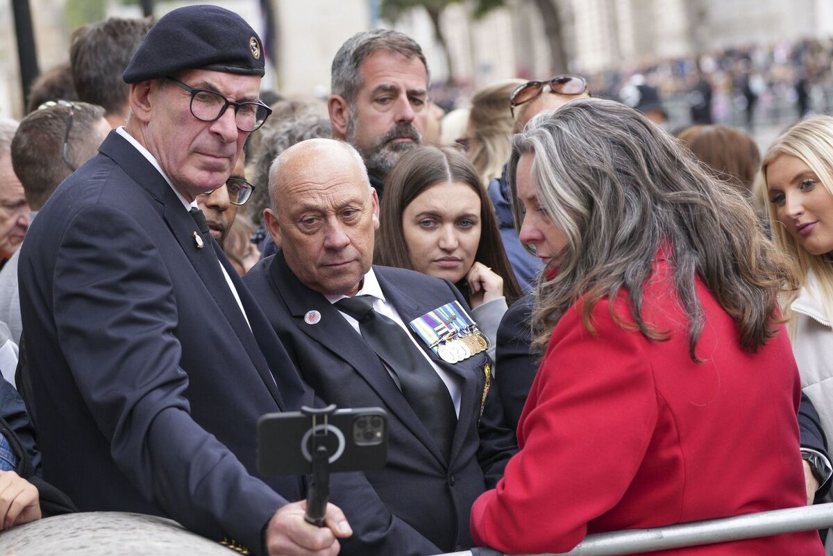 Members of the crowd take a selfie photograph ahead of to the funeral service of Queen Elizabeth II. Picture: Scott Garfitt/PA Wire Members of the crowd take a selfie photograph ahead of to the funeral service of Queen Elizabeth II. Picture: Scott Garfitt/PA Wire