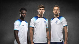 <p>England's Bukayo Saka, John Stones and Harry Kane wearing the new England home kit. Kane will wear an anti-discrimination armband during the World Cup in Qatar. Pic: The FA/PA</p>