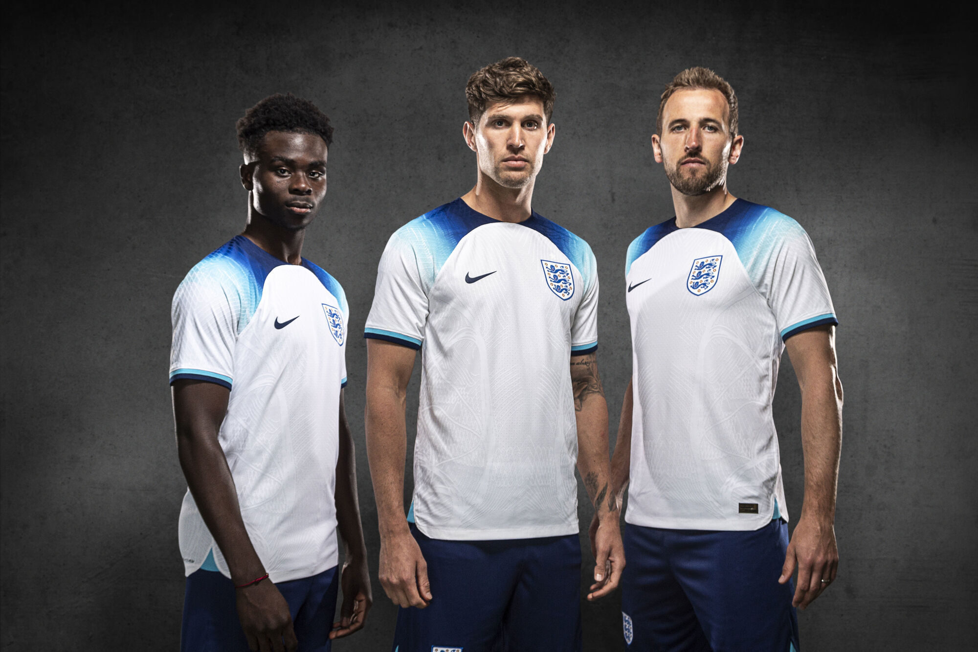 England's Bukayo Saka, John Stones and Harry Kane wearing the new England home kit. Kane will wear an anti-discrimination armband during the World Cup in Qatar. Pic: The FA/PA