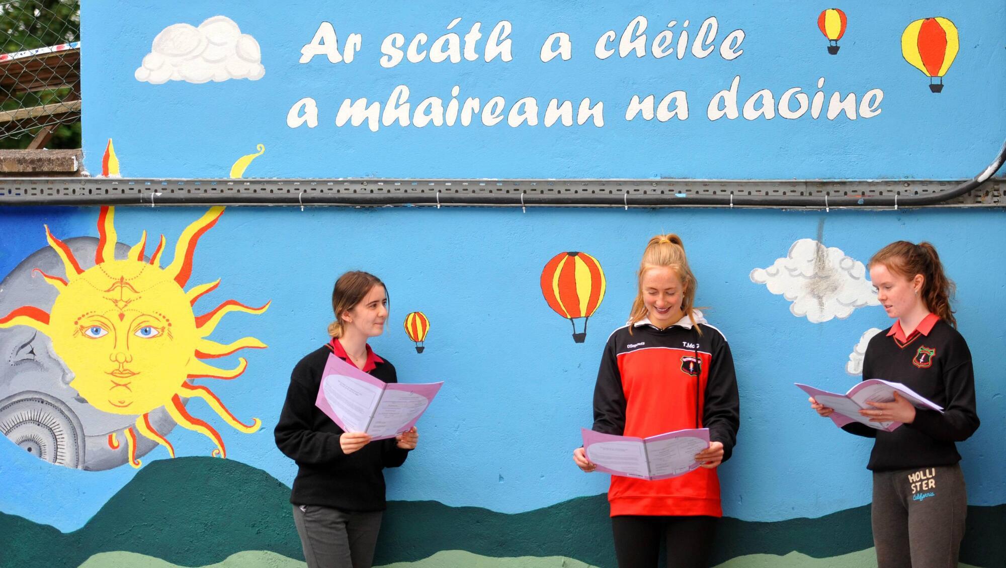 An atmosphere of "welcome, fairness, openness and respect" is fostered at Coláiste an Phiarsaigh, whose students Avril Ni Mathuna, Jill Ni Fhloinn, and Cait Ni Crulaoi are pictured here after  the 2021 Leaving Cert French exam.