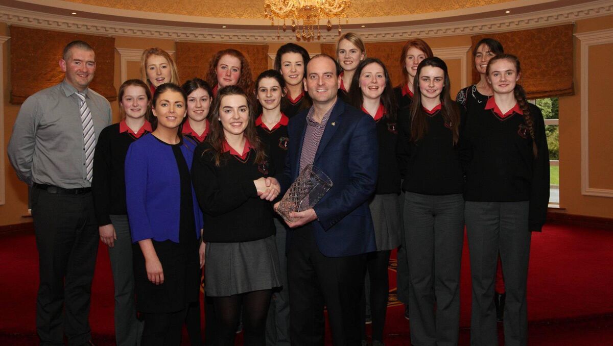 Micheál O Tuama, Príomhoide Coláiste an Phiarsaigh, pictured far left as he and his pupils accepted their award for camogie success at the Cork Sports, Business and Community Awards in 2019.