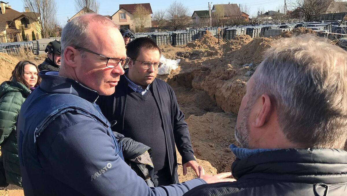 Foreign Affairs Minister Simon Coveney at the site of mass graves where more than 50 bodies were found in Bucha, Ukraine. Picture: PA