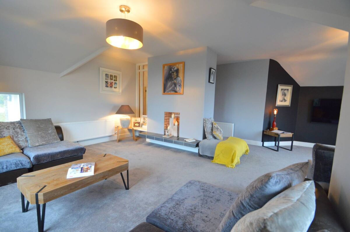 The upstairs living room is a retreat with a rare, dark wall for contrast. The upstairs living room is a retreat with a rare, dark wall for contrast.
