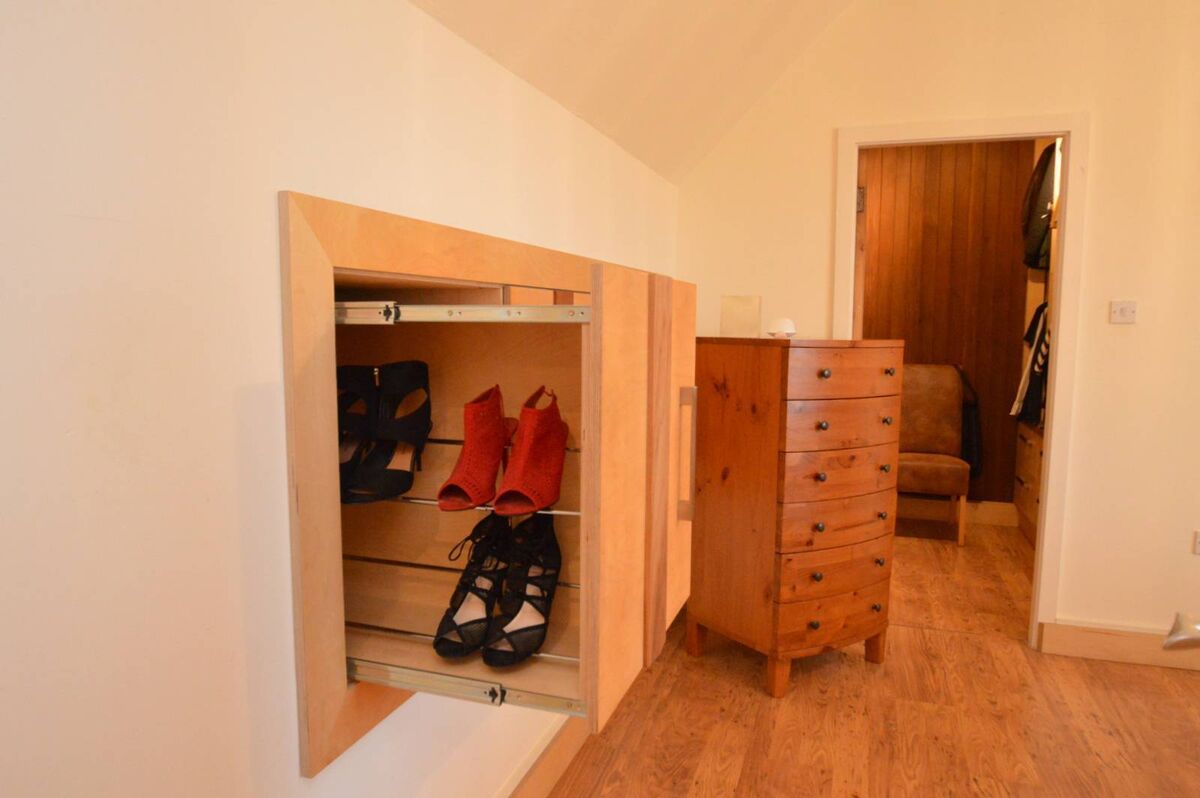 Bespoke designed pull-out storage and shelving from dormer eaves. Bespoke designed pull-out storage and shelving from dormer eaves.