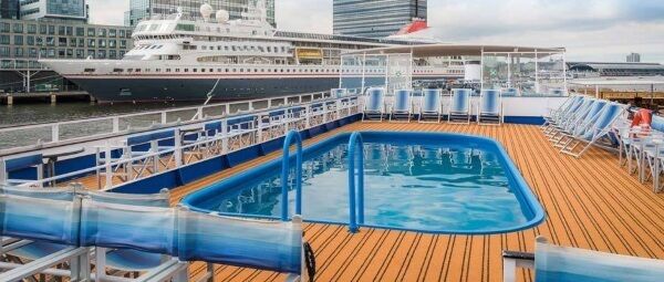 The vessel, which has accommodation for over 150 people, a sun deck, and a swimming pool, is currently based in Rotterdam, the Netherlands.