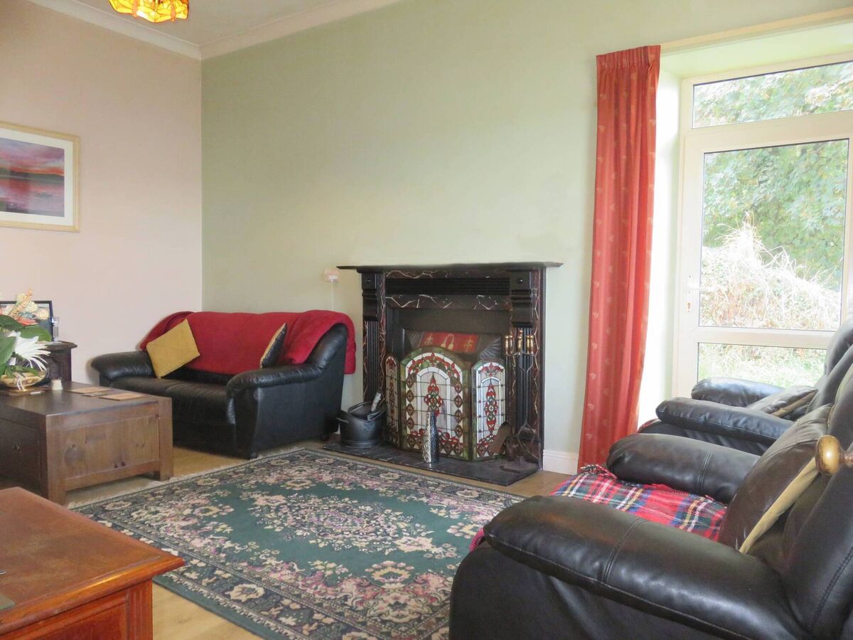 Good fireplace in end living room with glazed, single door to the side patio