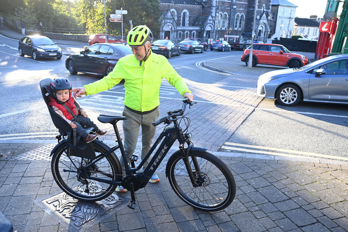  Shane Clarke, pictured on his electric bike with his son Oisin, looks set to lose a parking space outside his home on Wellington Rd. Picture: Larry Cummins