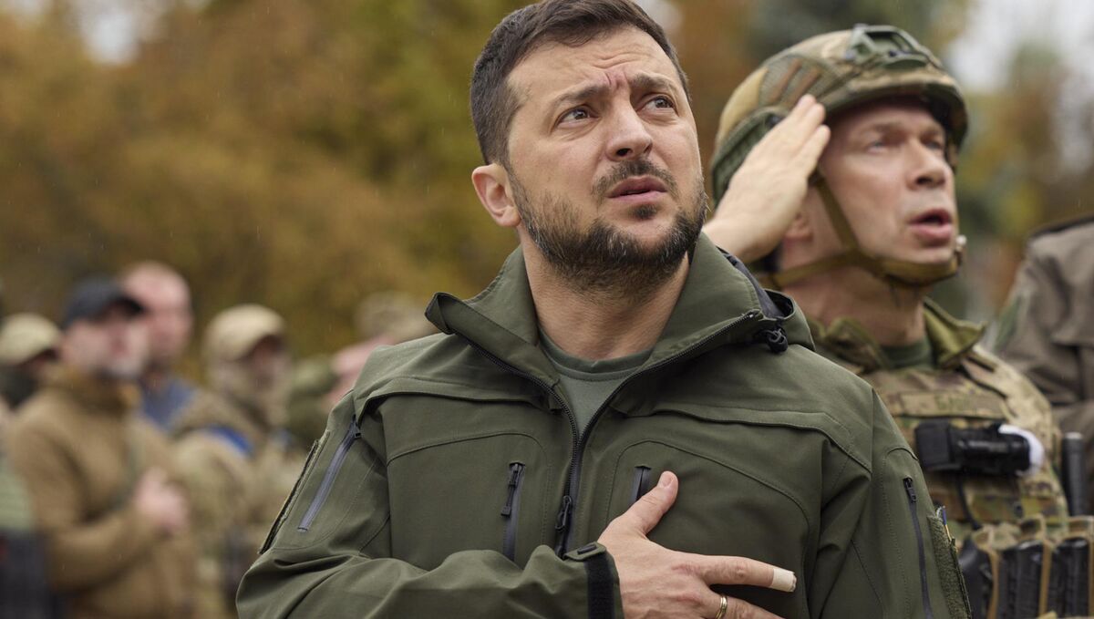 Ukrainian president Volodymyr Zelenskyy sings the Ukrainian national anthem during his visit to the city of Izium. Picture: Ukrainian Presidential Press Office via AP
