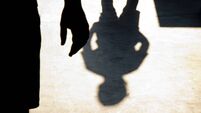 Blurry shadow silhouette of two boys confronting each other
