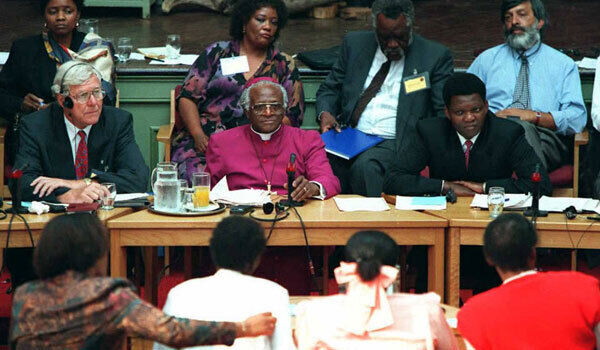 Archbishop Desmond Tutu with fellow commissioners listen to testimony from witnesses during the start of the Truth and Reconciliation Commission for South Africa.