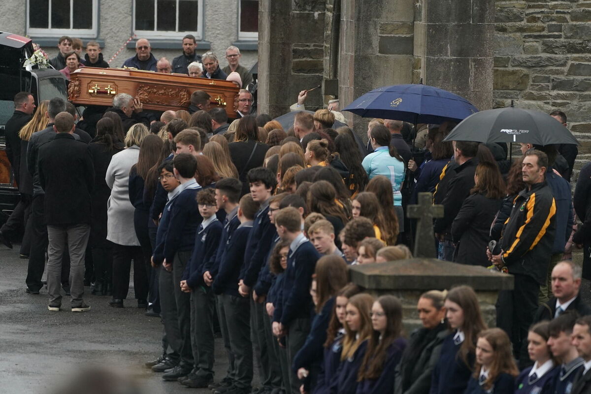 Family members and mourners help carry the coffin of 14-year-old Leona Harper. Picture: Brian Lawless/PA 