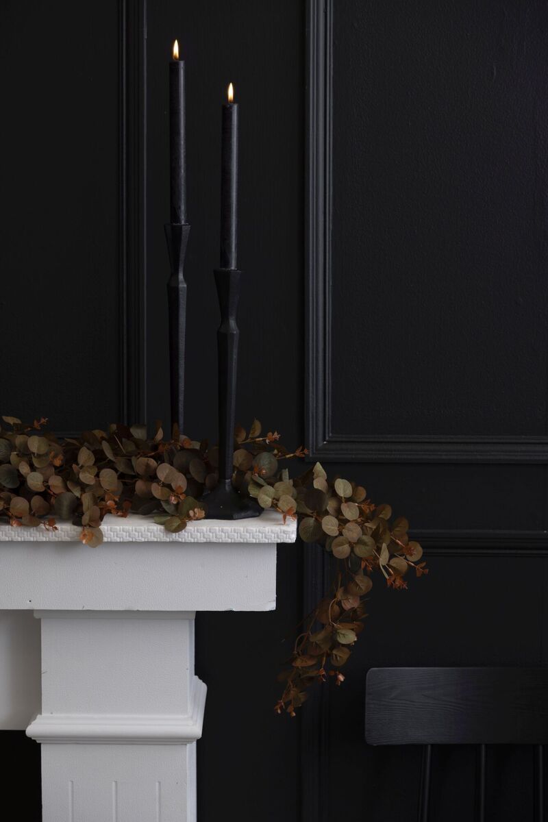  Mantlepieces come into their own for seasonal decorating. Here the Hilma candleholders (from €30) give height and textural contrast to the faux eucalyptus Harvest garland (€30). From Meadows &amp; Byrne.