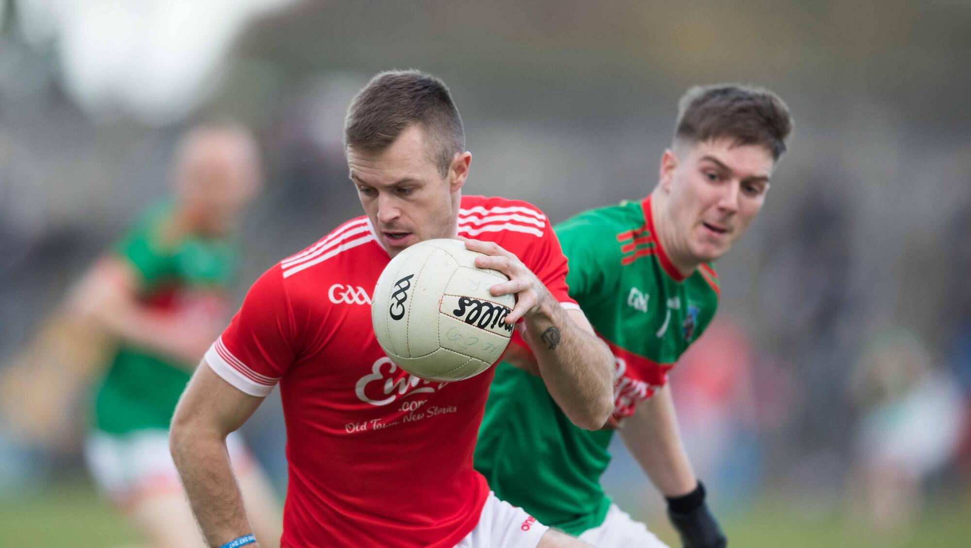  READING THE GAME: Eire Óg's Ciarán Russell with and Kilmurry Ibrickane's Andrew Shannon in last year's Clare SFC final at Cusack Park. Pic: Eamon Ward
