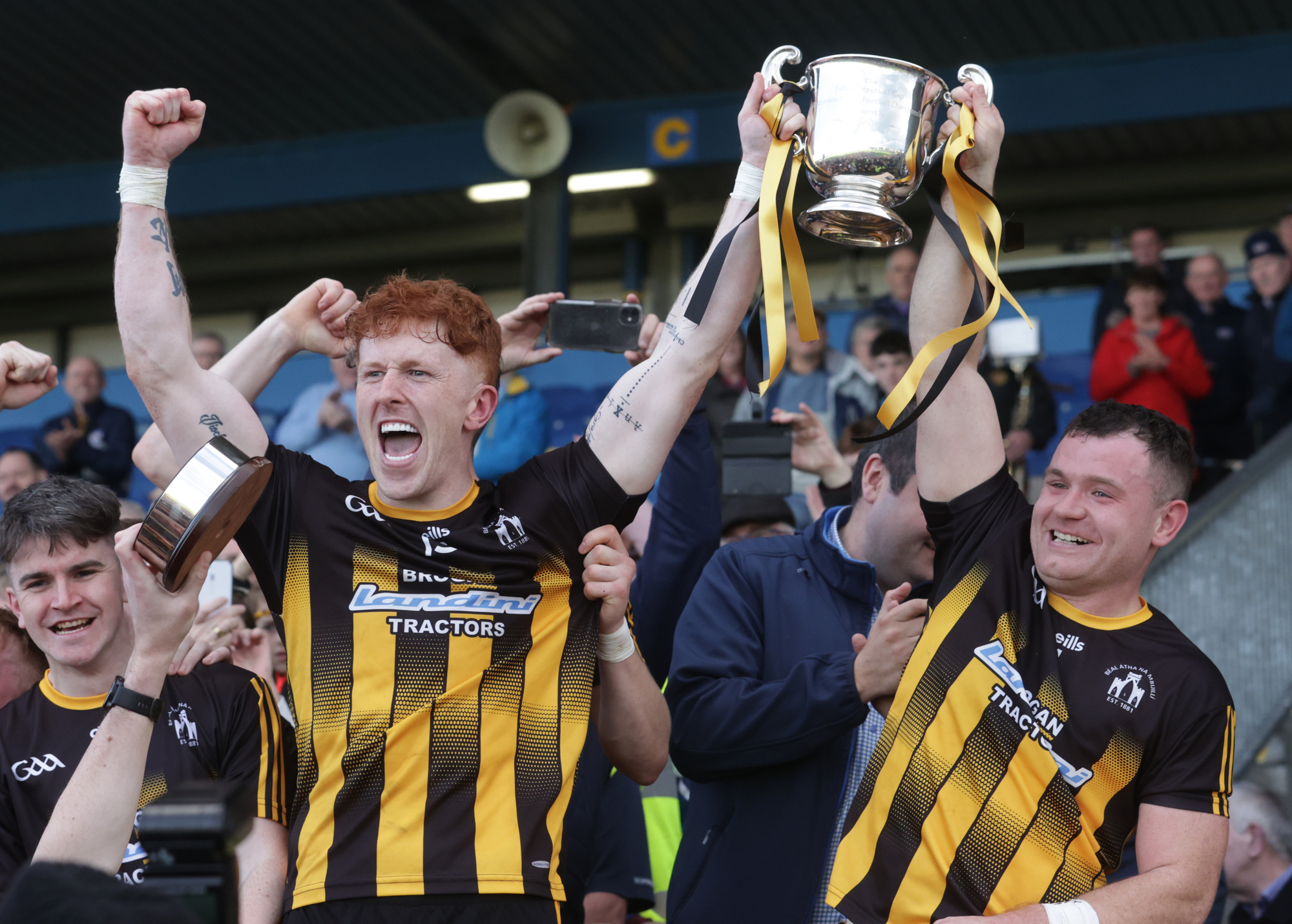 SMILES ALL-ROUND: Strokestown's captains Diarmuid McGann and David Neary celebrate their win. ©INPHO/John McVitty