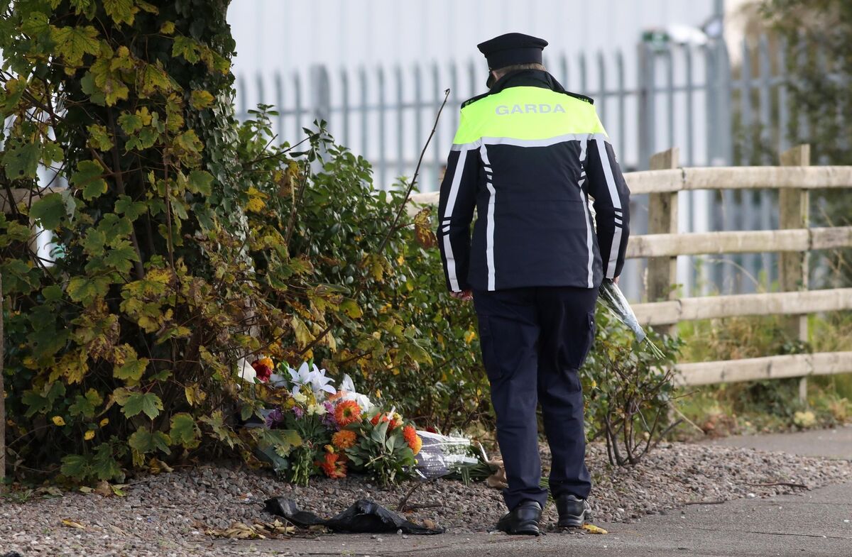 A garda leaves flowers at the scene at the Creeslough explosion. Picture: Sasko Lazarov/RollingNews.ie