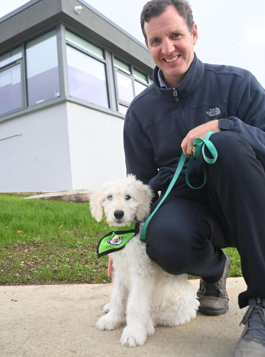  Teacher Kevin Byrne with the school dog 'Kerry', from My Canine Companion, at Scoil Bernadette