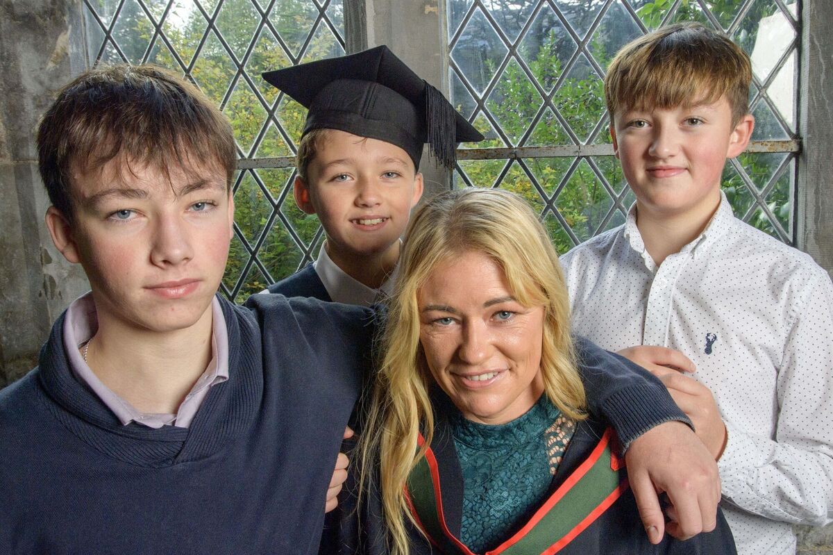 Helena Kiely (second from right) with her children Robert (16), Tommy !11) and Peter (12) at the graduation. "I’d be joking with my boys ‘this is our degree, it’s not just mammy’s degree’.” Picture: Daragh Mc Sweeney/Provision
