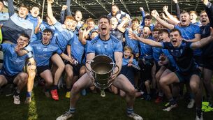 <p>DELIVERANCE: Lee Keegan lifts the trophy as Westport celebrate winning the match. Pic: INPHO/Tom Maher</p>