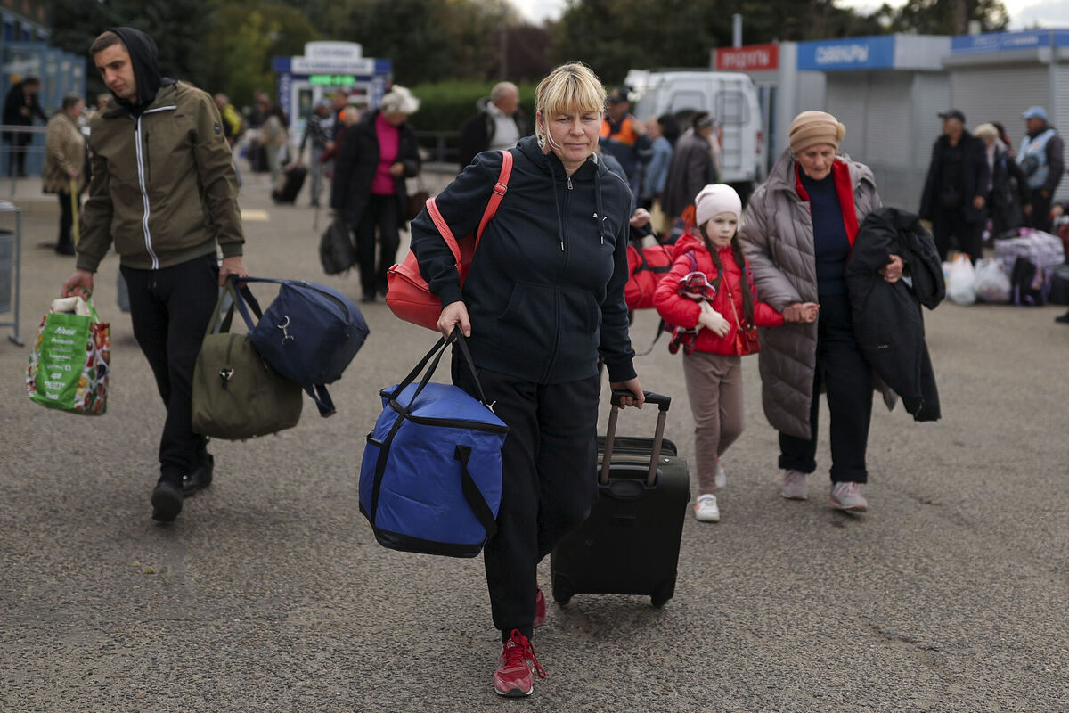 Evacuees from Kherson gather upon their arrival at the railway station in Anapa, southern Russia, Tuesday, October 25. Russian authorities have encouraged residents of Kherson to evacuate, warning that the city may come under massive Ukrainian shelling. Picture: AP Photo