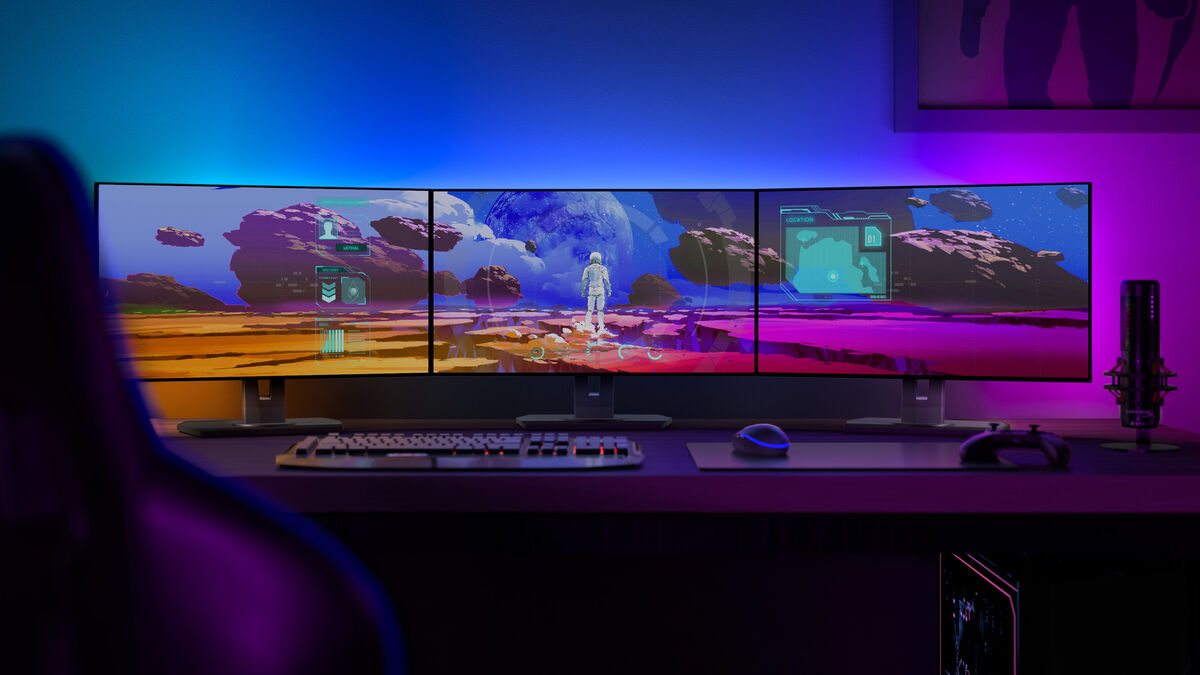 Philips Hue Play Gradient Lightstrip for PC on a triple monitor setup. Picture: Philips. Philips Hue Play Gradient Lightstrip for PC on a triple monitor setup. Picture: Philips.