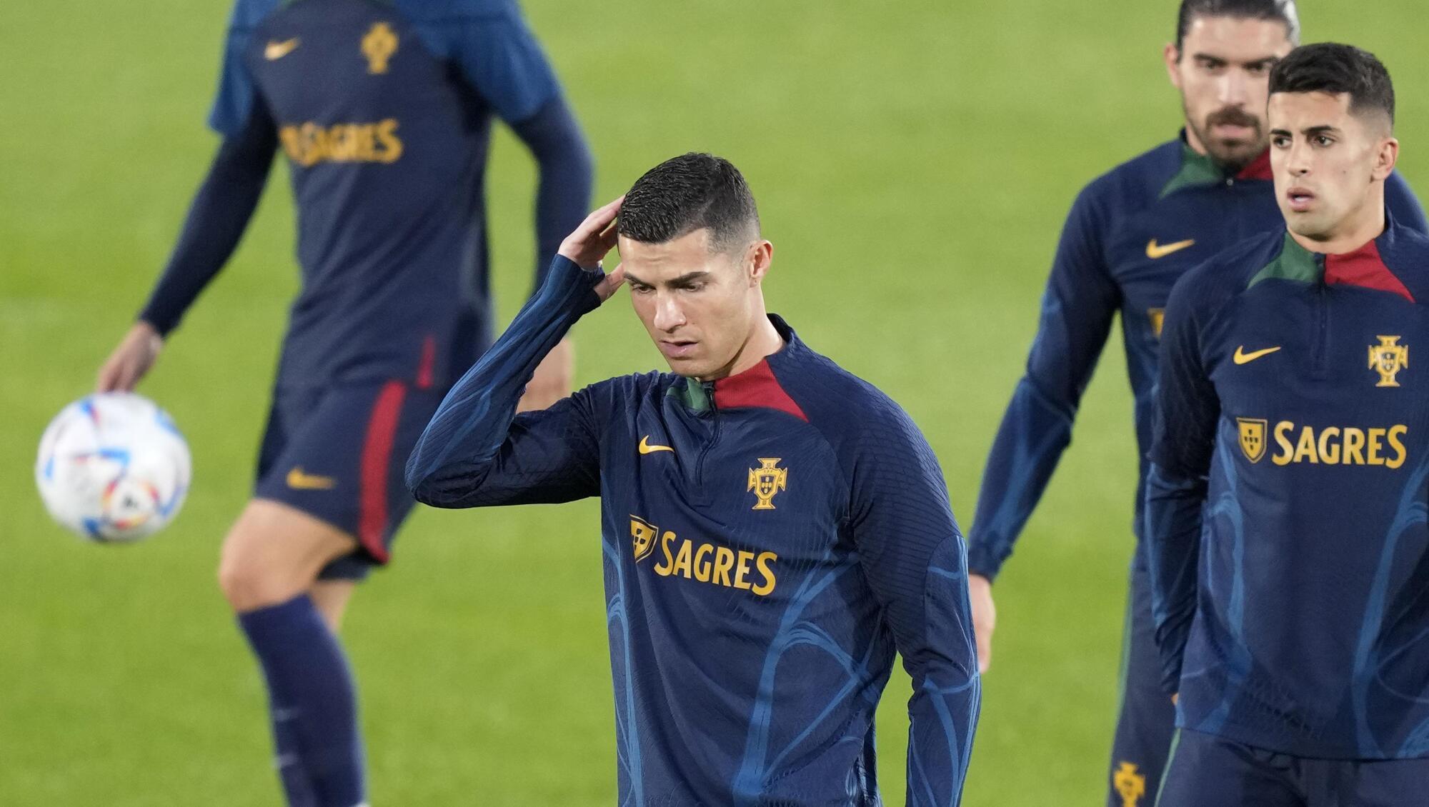 HEAD SCRATCHER: Cristiano Ronaldo, center, during a Portugal soccer team training in Oeiras, outside Lisbon. Pic: AP Photo/Armando Franca