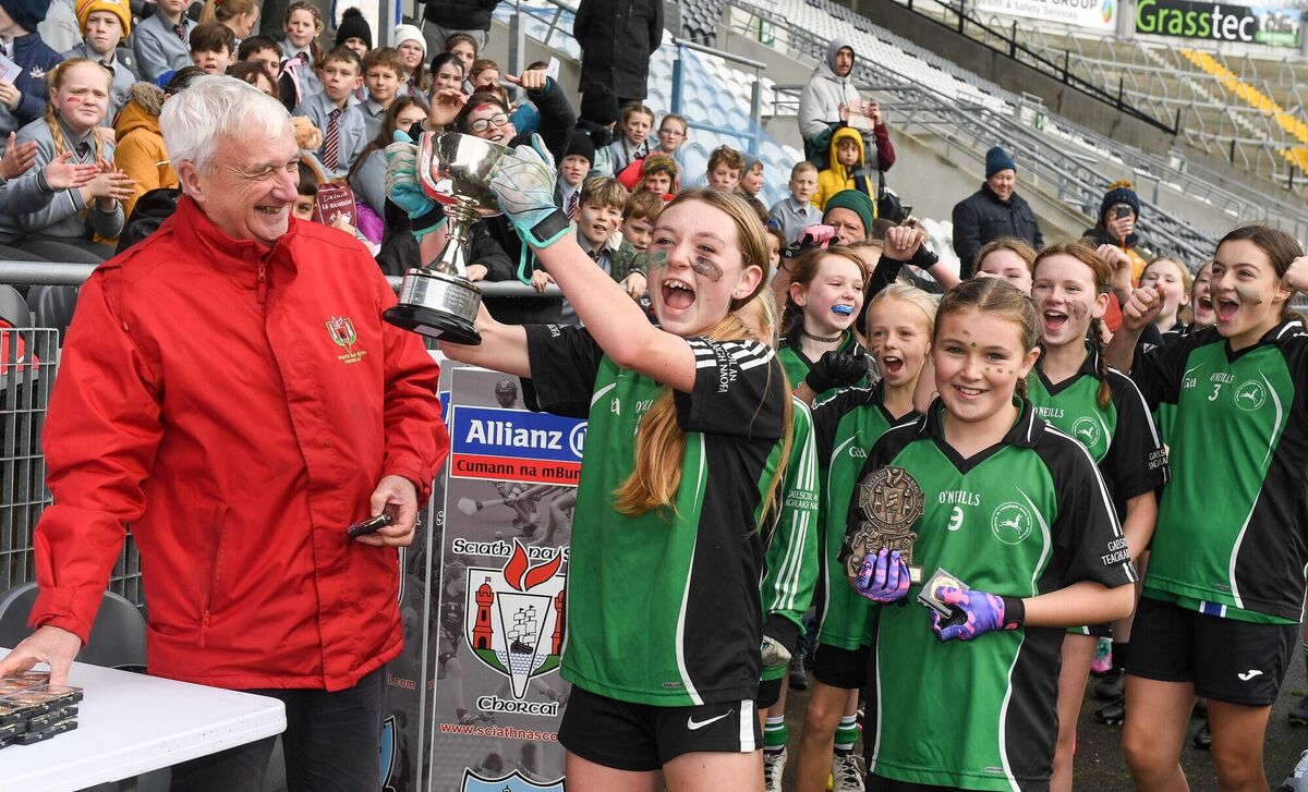  GS Teaghlaigh Naofa captain Clodagh Ni Mhurchu, shows her delight with her team-mates after they defeated Padre Pio, in the Allianz Sciath na Scol Urban DGF1 final at Pairc Ui Chaoimh. Also included is Donal Whooley who presented the cup.