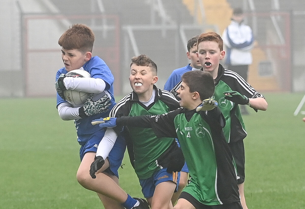  Sean Crean, St Mary's On The Hill, keeps possession under pressure from Luke O Mathuna and Donal Og O Tuama, GS Teaghlaigh Naofa.