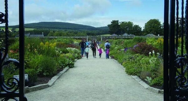 A view through gates of the staggeringly vast herbaceous border. A view through gates of the staggeringly vast herbaceous border.