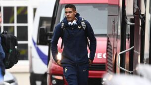 <p>France's national football team defender Raphael Varane (C) arrives at Le Bourget airport near Paris, on November 16, 2022, upon the team's departure for the 2022 Fifa World Cup in Qatar. (Photo by Christophe ARCHAMBAULT / AFP) </p>