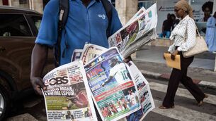 <p>HOLD THE FRONT PAGE: A man sells Senegalese newspapers, in Dakar, with headlines of Sadio Mane's knee injury. Picture: JOHN WESSELS/AFP via Getty Images)</p>