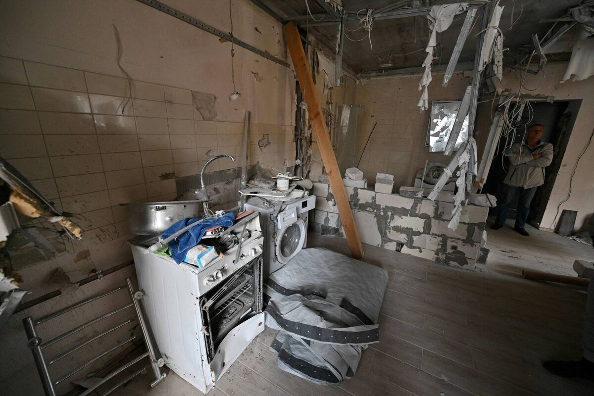 A man stands in a partially destroyed flat in an apartment block in Irpin, in September. Picture: Getty
