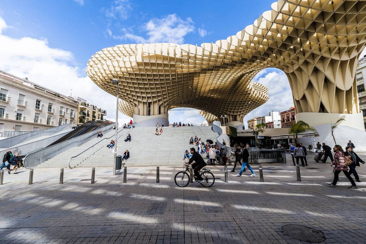 Plaza de la Encarnación in the old quarter of Seville at noon. The prominent wooden architecture is the Metropol Parasol by architect Jurgen Mayer.