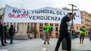 <p>MADRID, SPAIN - 2022/11/19: A man is seen with a pick and chained to a football ball during a protest against the FIFA World Cup Qatar 2022. People gathered to protest under the slogan 'No to the world cup of shame' denouncing that in the construction of infrastructures at least 6,500 immigrant workers have died. (Photo by Marcos del Mazo/LightRocket via Getty Images)</p>