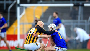 <p>Ballyea's Martin O'Leary commiserates with Ciaran Doolan of St Finbarr's. Picture: INPHO/Evan Treacy</p>